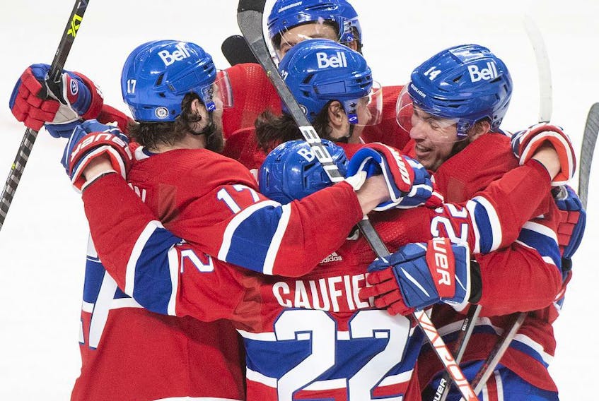  Canadiens’ Nick Suzuki, right, celebrates with teammates after scoring against the Seattle Kraken during third period NHL hockey action in Montreal on Saturday, March 12, 2022.
