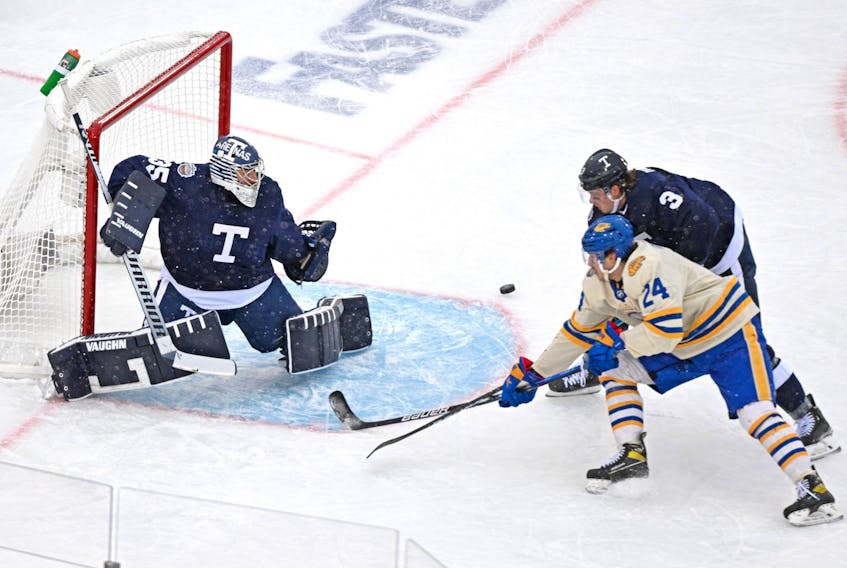 Maple Leafs goalie Petr Mrazek makes a save as Leafs defenceman Justin Holl covers Buffalo Sabres' Dylan Cozens during the first period of the Heritage Classic at Tim Hortons Field in Hamilton on Sunday, March 13, 2022. 