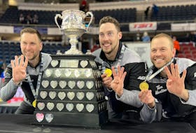 Team Gushue's (from left) Brad Gushue, Brett Gallant and Geoff Walker pose with the Brier trophy after defeating Kevin Koe's rink in an extra end. Missing from the photo is Mark Nichols who was unable to compete with the rink in the playoff round after testing positive for COVID-19.