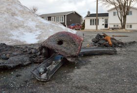Burned car parts sit on the pavement at the end of Marconi Place in Mount Pearl Monday, March 14. Keith Gosse • The Telegram