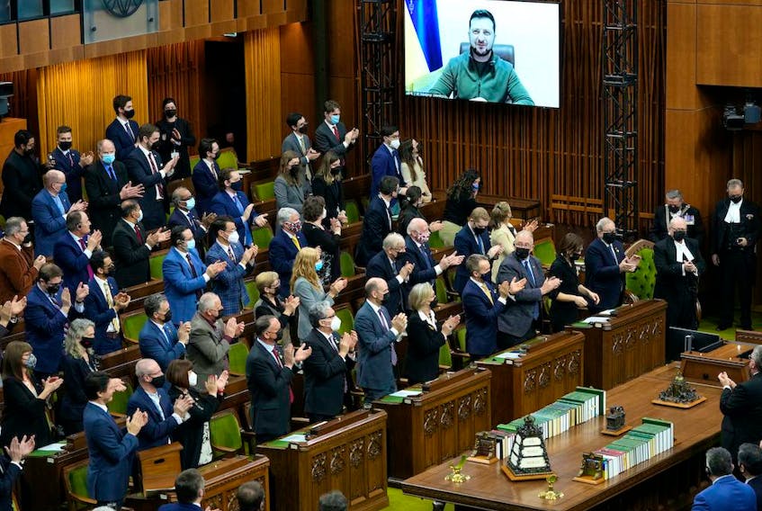 Ukrainian President Volodymyr Zelenskyy receives a standing ovation as he appears via videoconference to make an address to Parliament, in the House of Commons on Parliament Hill in Ottawa, on Tuesday, March 15, 2022. THE CANADIAN PRESS/Justin Tang 