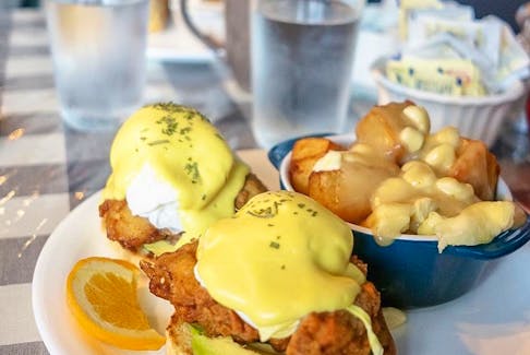 The buttermilk fried chicken eggs benedict at Claudine’s Eatery in Fredericton is made even richer with thick slices of avocado, and a side of home fry poutine. Gabby Peyton photo