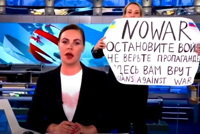 Marina Ovsyannikova, an editor for the the popular state-owned Russian television station Channel One, appeared behind anchor Ekaterina Andreeva with a sign that read “NO WAR” in English.