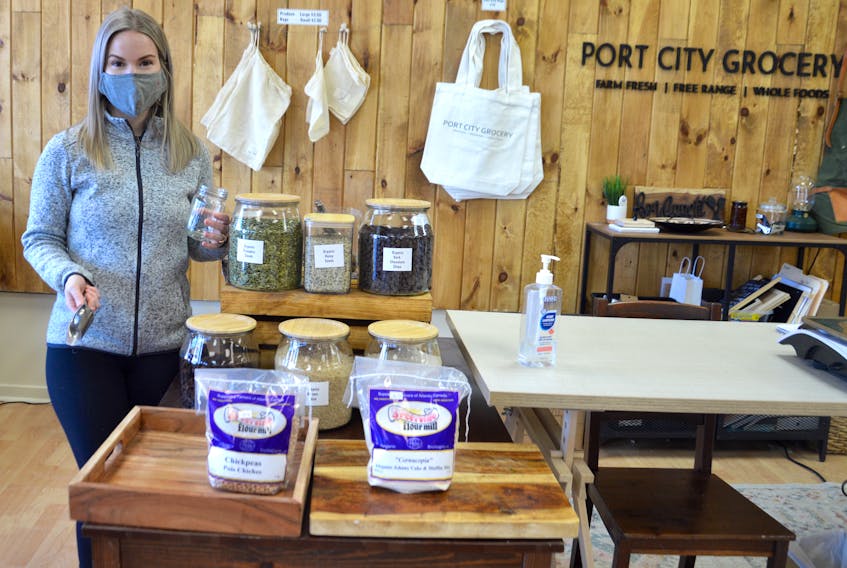 Kat Gouthro holds a jar customers can use to buy package-free items at Port City Grocery, the independent store she operates with her husband in downtown Sydney. Many of the items in the new section were previously sold in 910-gram plastic bags. Chris Connors/Cape Breton Post 