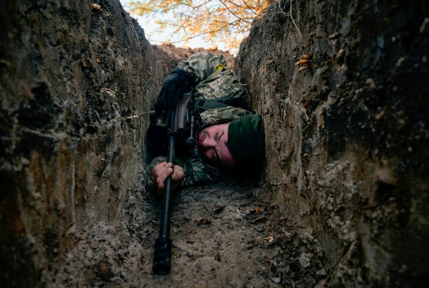 A Ukrainian soldier hides from a helicopter airstrike amid Russia's invasion of Ukraine, near Demydiv, Ukraine March 10, 2022.  REUTERS/Maksim Levin  A Ukrainian soldier hides from a helicopter airstrike amid Russia's invasion of Ukraine, near Demydiv, Ukraine, on March 10, 2022. REUTERS  /Maksim Levin