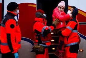 Paramedics help one of 20 children with chronic illnesses and cancer diagnosis fleeing the Russian invasion of Ukraine, at the border checkpoint in Medyka, Poland, March 10, 2022