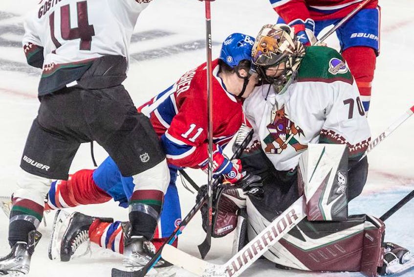 Montreal Canadiens right wing Brendan Gallagher (11) is driven into the shoulder of Arizona Coyotes goaltender Karel Vejmelka (70) during 2nd period NHL action at the Bell Centre in Montreal on Tuesday, March 15, 2022. 