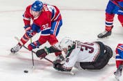 Montreal Canadiens centre Rem Pitlick (32) battles with Arizona Coyotes right wing Christian Fischer (36) for the loose puck during 2nd period NHL action at the Bell Centre in Montreal on Tuesday March 15, 2022.