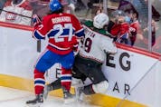 Montreal Canadiens defenseman Alexander Romanov (27) checks Arizona Coyotes centre Barrett Hayton (29) into the boards during 3rd period NHL action at the Bell Centre in Montreal on Tuesday, March 15, 2022.