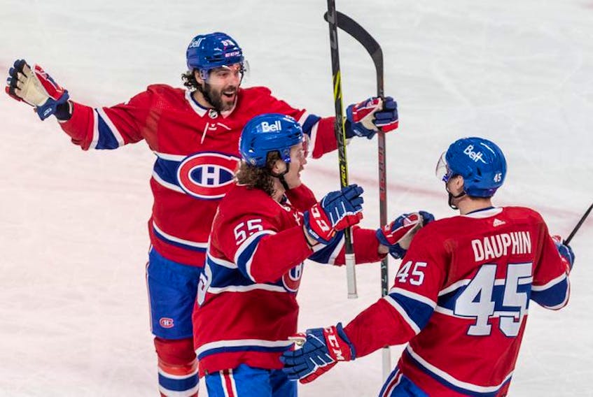 Montreal Canadiens centre Laurent Dauphin (45) is congratulated by teammates Michael Pezzetta (55) and Mathieu Perreault (85) during 1st period NHL action at the Bell Centre in Montreal on Tuesday, March 15, 2022.