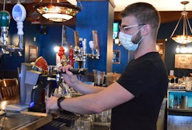 Bartender James Patterson draws a pint of Guinness at the Old Triangle.