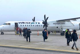 WestJet passengers make their way across the tarmac after landing at the J.A. Douglas McCurdy Sydney Airport in this file photograph. The airline has announced it is increasing the frequency of its Sydney-Halifax service to once-a-day as of May 1. WestJet is presently offering the regional flight on a three times per week basis. CAPE BRETON POST PHOTO