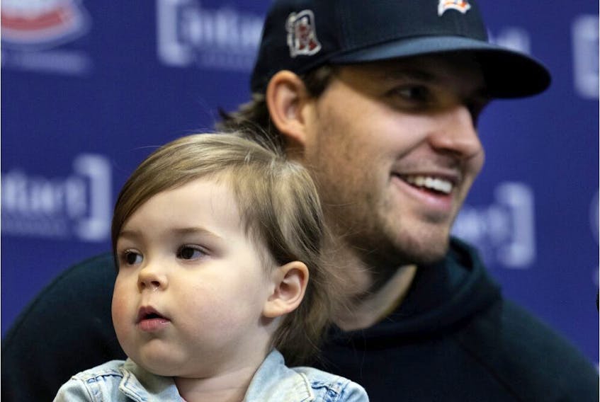 Former Montreal Canadiens defenceman Ben Chiarot speaks to the media with his daughter, Emmerson, during a news conference in Montreal on Thursday, March 17, 2022.