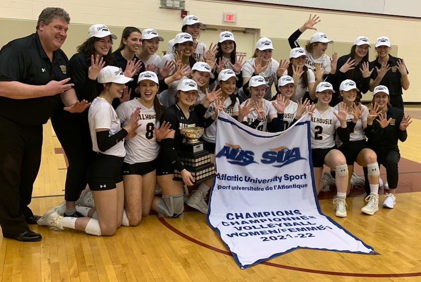 The Dalhousie Tigers celebrate after winning their ninth consecutive Atlantic University Sport women's volleyball championship on Thursday night at the Homburg Centre. The Tigers defeated Saint Mary's 3-0 to sweep the best-of-three championship series.