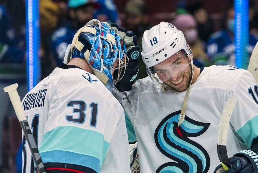 Seattle Kraken forward Calle Jarnkrok (at right) celebrates with goalie  Philipp Grubauer after a recent victory over the Canucks at Rogers Arena in Vancouver.