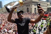  Kawhi Leonard takes a selfie holding his playoffs MVP trophy as he celebrates during the 2019 Toronto Raptors Championship parade in Toronto on June 17, 2019.