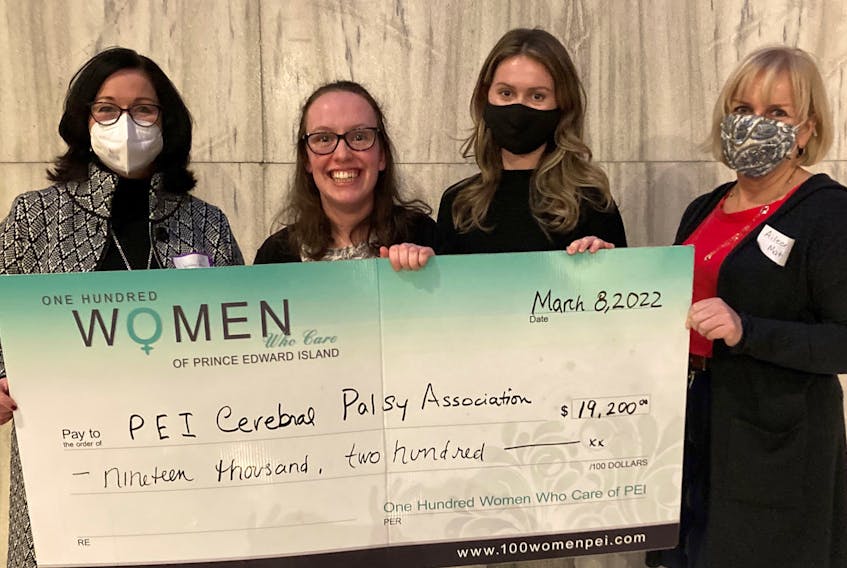 Kathleen Casey, left, and Aileen Matters, right, two members of 100 Women Who Care P.E.I., present a cheque recently, to Hannah MacLellan, second left, and Hillary Campbell, co-presenters from the P.E.I. Cerebral Palsy Association. 