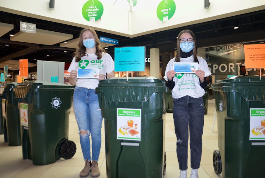 Neely Pheifer, left, and Claire Morrison are part of the volunteer youth team that is helping staff a waste and recycling management display at the Mayflower Mall. The information kiosk, which runs through Sunday, is a partnership between the mall and the Cape Breton Regional Municipality’s solid waste department. DAVID JALA/CAPE BRETOPN POST
