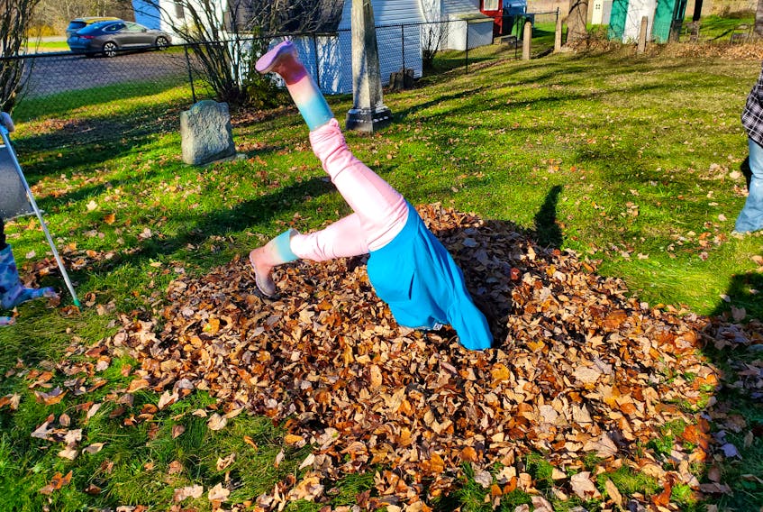 Willow Belliveau, 8, was one of the many helpers who volunteered to rake during the fall clean-up at the Old Tremont Cemetery. She also did a cartwheel through a pile of leaves. 