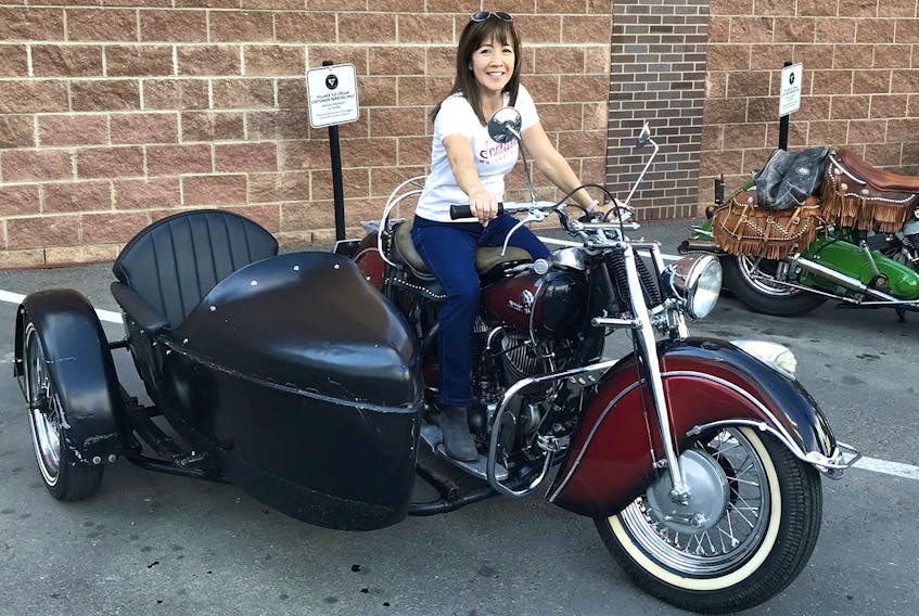 Jack Leong’s daughter, Denise Eckert, with a circa 1946/47 Indian Chief owned by Ace-Hy member Robert Olivier. Eckert had never been on a motorcycle before attending the Ace-Hy motorcycle meet-up at Calgary’s Village Ice Cream, where Olivier took her for a short spin in the similar make and model machine her father once owned. Contributed/Kimberly Eckert