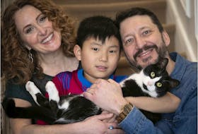 “There aren’t always happy endings," Schwartz said. "But I had one. So if it helps someone hold on to hope, then I’ve accomplished what I set out to do," said Tarah Schwartz, pictured with her son, Sam, her husband, Enrico Caouette, and the family cat, Milo, at their home on March 18, 2022.