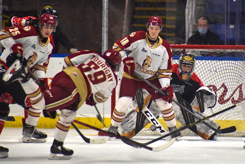 Remi Delafontaine of the Cape Breton Eagles, right, looks around Dylan Andrews of the Acadie-Bathurst Titan parked in front of the net as Titan defenceman Miguel Tourigny fires a shot on goal during Quebec Major Junior Hockey League action at Centre 200 on Friday. Acadie-Bathurst won the game 7-3. JEREMY FRASER/CAPE BRETON POST.