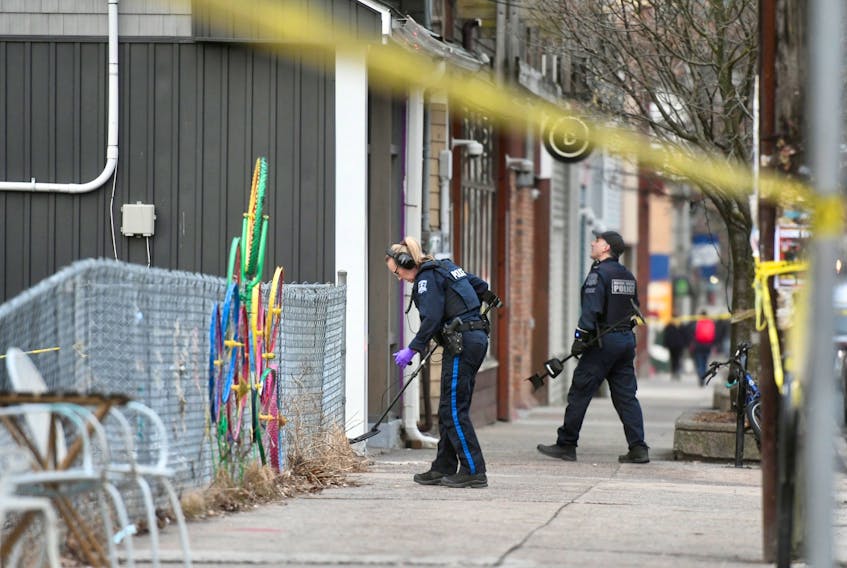 Halifax Regional Police officers investigate a shooting scene on Gottingen Street on Friday, March 18, 2022.