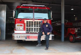 Summerside Fire Chief Ron Enman sits on one of the department's engines at Station 1 on Foundry Street. After years of planning, the city is moving to replace the aged fire hall.