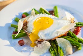 A the runny yolk of a fried egg acts as a sauce for this asparagus dish.