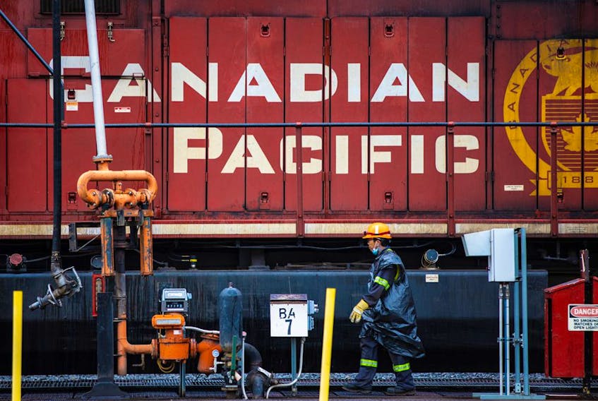 A CP Rail employee walks past locomotives in the Alyth yards in Calgary.