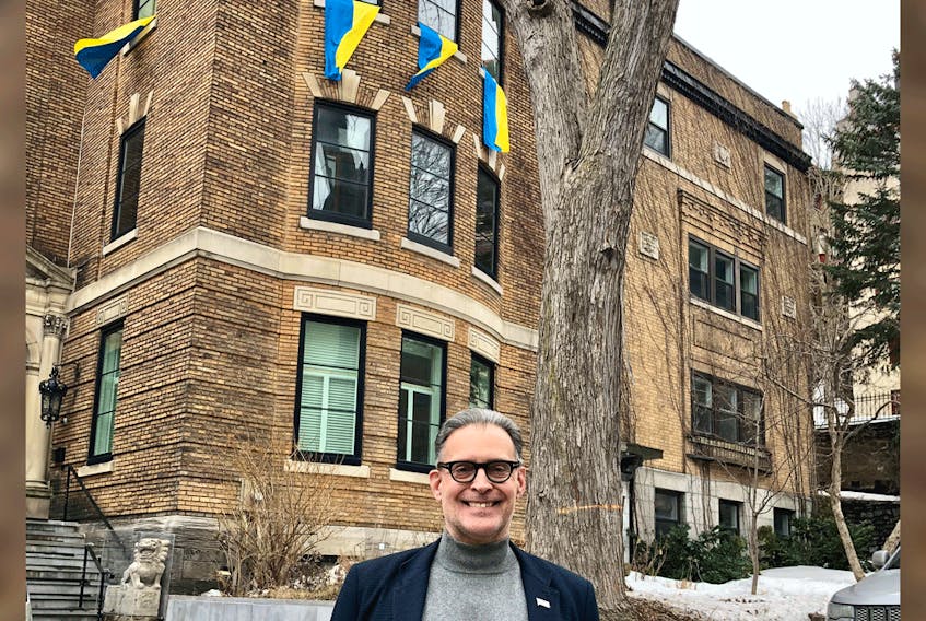 Montreal city councillor Serge Sasseville lives in front of the city’s Russian consulate. He has hung four Ukrainian flags in his windows in plain view of the consulate.