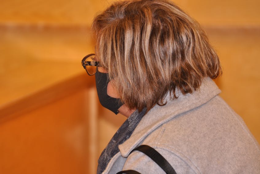 Melissa Williams kept her head turned from view when she appeared in provincial court in Corner Brook on Dec. 1, 2021. Williams pleaded guilty that day to two charges of defrauding the Corner Brook Minor Hockey Association.