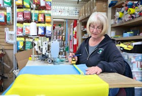 Wanda Heffernan measures material to make the a Ukrainian flag. Orders for the flag have been steadily coming in from across the province since Russia’s invasion of Ukraine began last Thursday.

