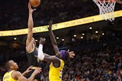  Scottie Barnes #4 of the Toronto Raptors puts up a shot over Wenyen Gabriel #35 of the Los Angeles Lakers during the second half of their NBA game at Scotiabank Arena on March 18, 2022 in Toronto, Canada. Photo by Cole Burston/Getty Images