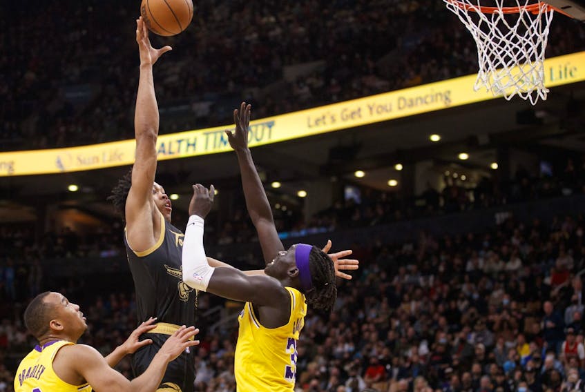  Scottie Barnes #4 of the Toronto Raptors puts up a shot over Wenyen Gabriel #35 of the Los Angeles Lakers during the second half of their NBA game at Scotiabank Arena on March 18, 2022 in Toronto, Canada. Photo by Cole Burston/Getty Images