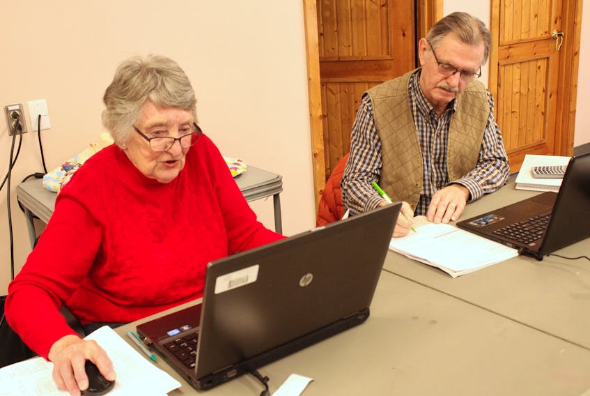 In this file photo from 2020, longtime tax clinic volunteer Pauline McLean, left, trains Jim Gunn who recently decided to donate his time to the Community Volunteer Income Tax Program after he recently retired. The pair was busy working at the clinic hosted at the Glace Bay Library. ERIN POTTIE/CAPE BRETON POST