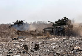 Service members of pro-Russian troops are seen atop of tanks during Ukraine-Russia conflict on the outskirts of the besieged southern port city of Mariupol, Ukraine, Sunday, March 20, 2022.