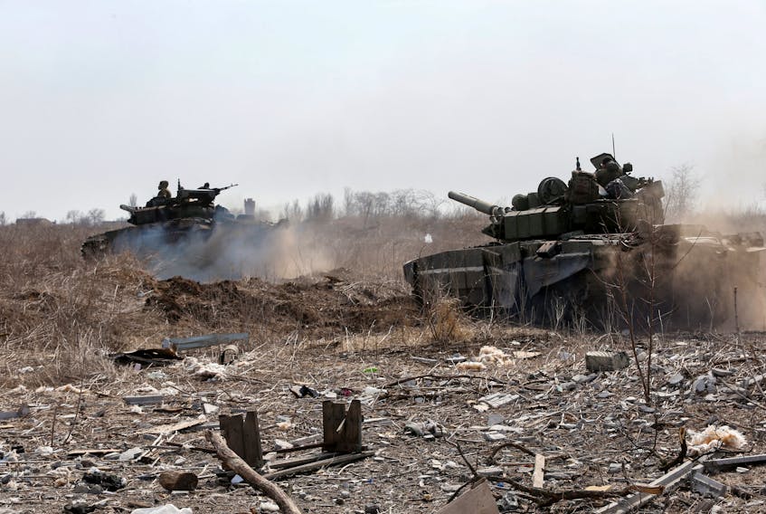 Service members of pro-Russian troops are seen atop of tanks during Ukraine-Russia conflict on the outskirts of the besieged southern port city of Mariupol, Ukraine, Sunday, March 20, 2022.