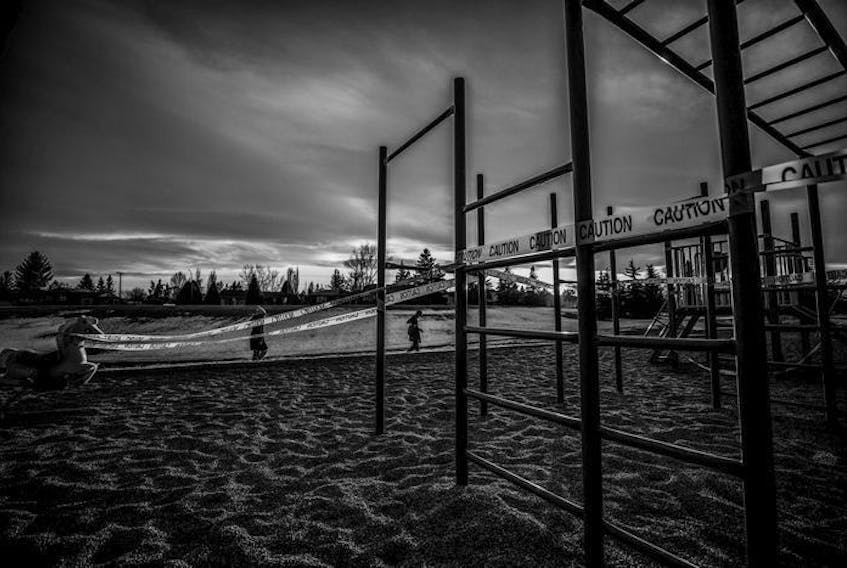  Warning tape cordons off a Calgary playground during the early days of the COVID-19 pandemic. From photojournalist Leah Hennel’s new book, Alone Together. Photo by Leah Hennel