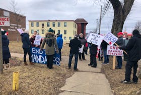 Approximately two dozen people gathered outside of the Cape Breton-Victoria Regional Centre for Education building on George St. in Sydney on Wednesday morning to show their opposition to the temporary extension of masking requirements in schools.