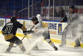 Jack Campbell of the Cape Breton Eagles, 12, makes a move on Lukas Cormier, 51, of the Charlottetown Islanders, left, during Quebec Major Junior Hockey League action at Centre 200 on March 22. The Islanders won the game 4-2.