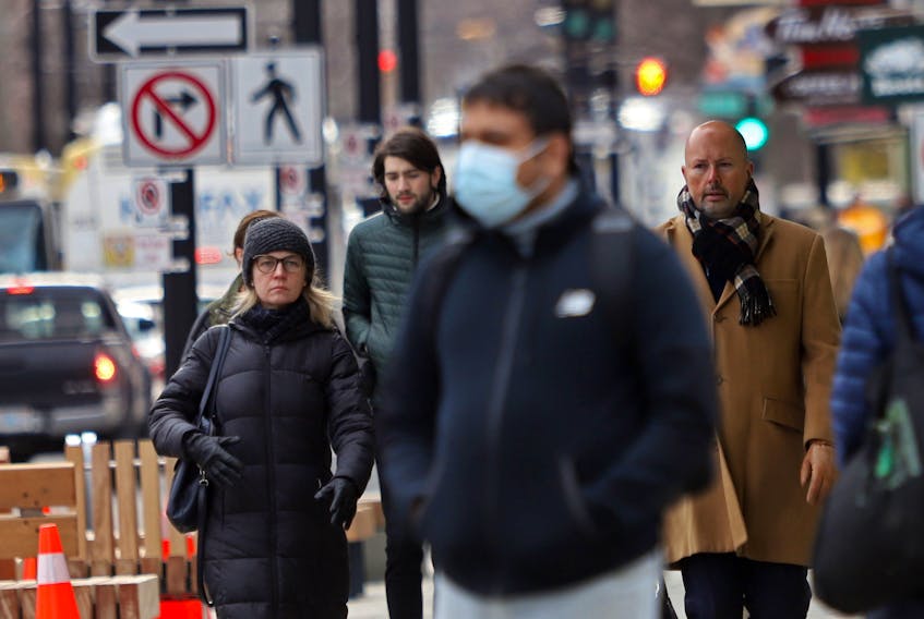 An array of mast and unmasked pedestrians are seeing on Spring Garden Road in Halifax Tuesday, March 22, 2022