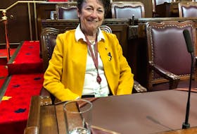 Former senator Diane Griffin sits at her old desk on March 23 inside the Senate chambers in Ottawa. Griffin retired from her role in the upper chamber on March 17.
