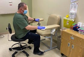 Medical laboratory assistant Dave Willis prepares a blood collection station for a new patient at the Western Memorial Health Clinic in Corner Brook.