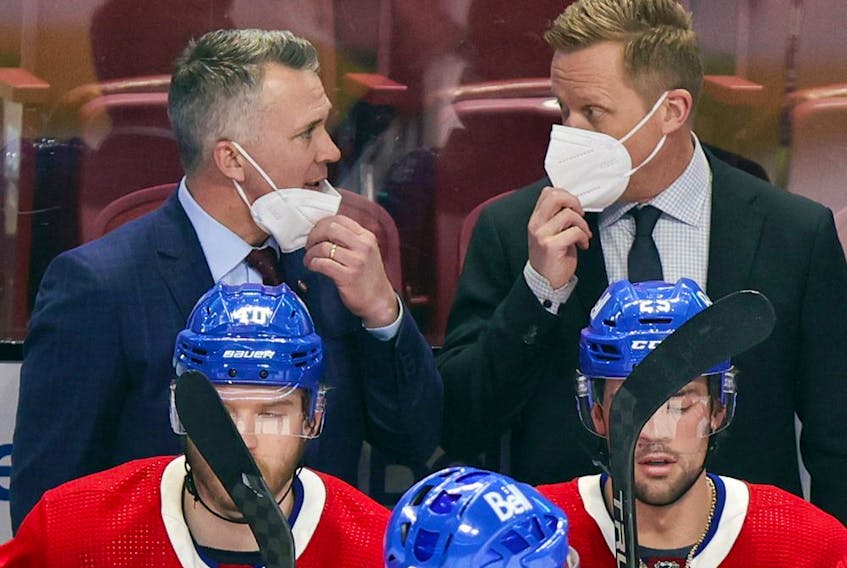 Canadiens interim head coach Martin St. Louis, left, consults with assistant coach Trevor Letowski on the bench during game against the Washington Capitals in Montreal on Feb. 10, 2022.