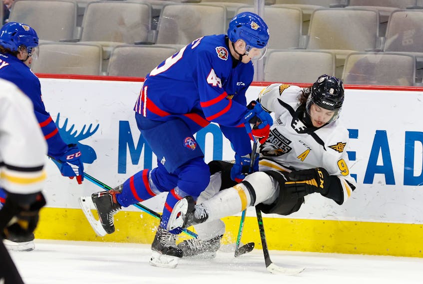 Maxim Barbashev of the Moncton Wildcats, left, throws a hit on Jérémy Langlois of the Cape Breton Eagles during Quebec Major Junior Hockey League action at the Avenir Centre in Moncton on Thursday. The Wildcats won the game 5-2. PHOTO CONTRIBUTED/DANIEL ST. LOUIS, MONCTON WILDCATS.
