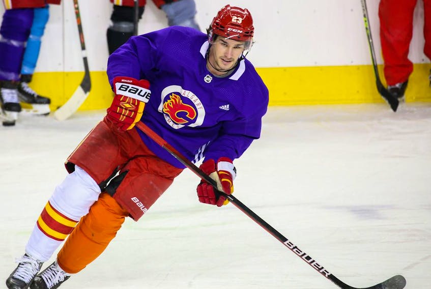Calgary Flames centre Sean Monahan skates during practice at Scotiabank Saddledome on Monday, March 21, 2022. Players skated with multicoloured socks in honour of World Down Syndrome Day.