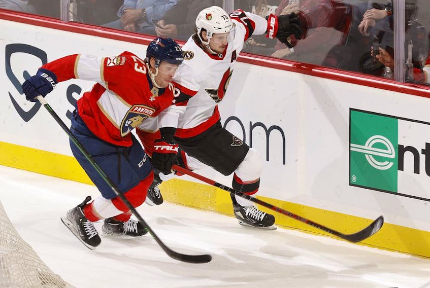 Carter Verhaeghe (23) of the Florida Panthers and Thomas Chabot (72) of the Ottawa Senators chase the puck in  the second period at FLA Live Arena on March 3, 2022 in Sunrise, Florida.
