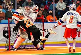 Buffalo Bandits forward Josh Byrne scores one of his three goals against Halifax Thunderbirds goalie Warren Hill as Ryan Terefenko looks on during a National Lacrosse League matinee Saturday in Buffalo, N.Y. - NATIONAL LACROSSE LEAGUE