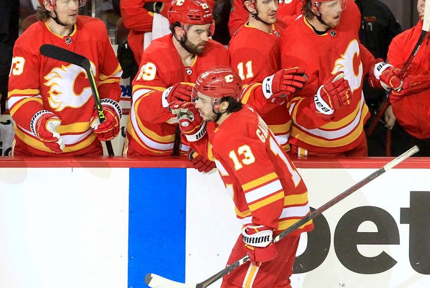 Calgary Flames forward Johnny Gaudreau of the celebrates with teammates after scoring his 200th NHL goal during a game against the Arizona Coyotes at Scotiabank Saddledome in Calgary on Friday, March 25, 2022.